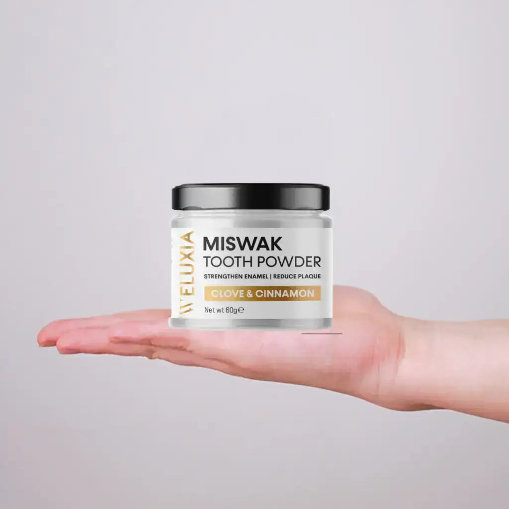 Open jar of Weluxia Miswak Tooth Powder showing fine herbal powder texture