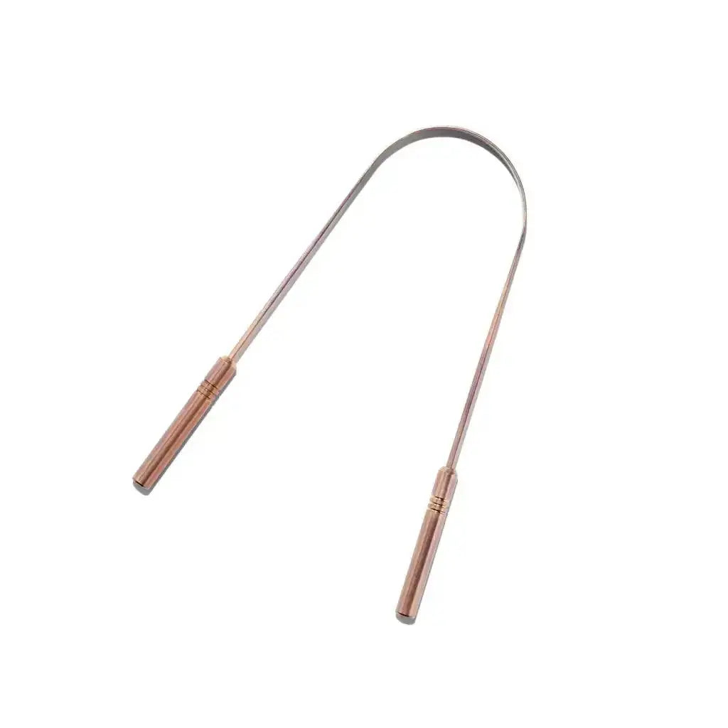 Close-up of traditional Ayurvedic copper tongue cleaner showing pure antibacterial U-shaped metal design